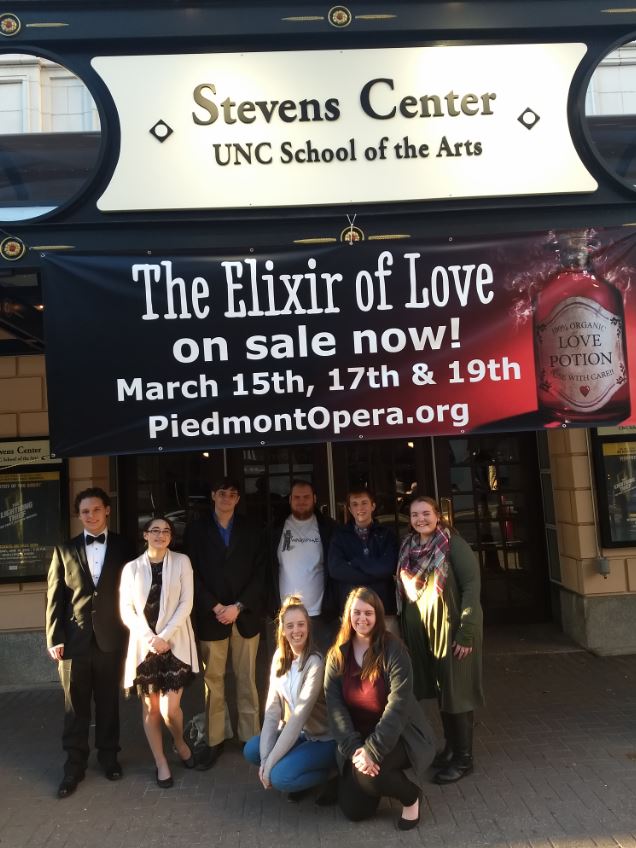 People Posed in front of a Theater