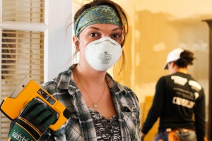 Woman Wearing a Safety Mask while holding a tool