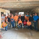 Group of people standing inside a building under construction