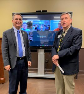 Dr. Scott Hummel and Brian Cutshall standing in front of a virtual meeting screen.