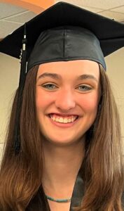 Young woman wearing a graduation cap smiling